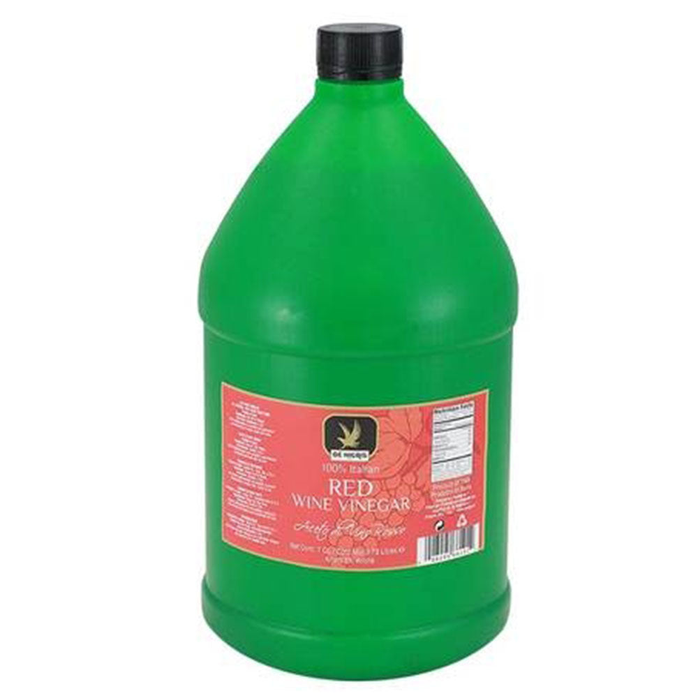 Green bottle of red wine vinegar with a black cap on a white background